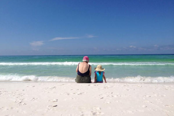 grandparent and child at beach